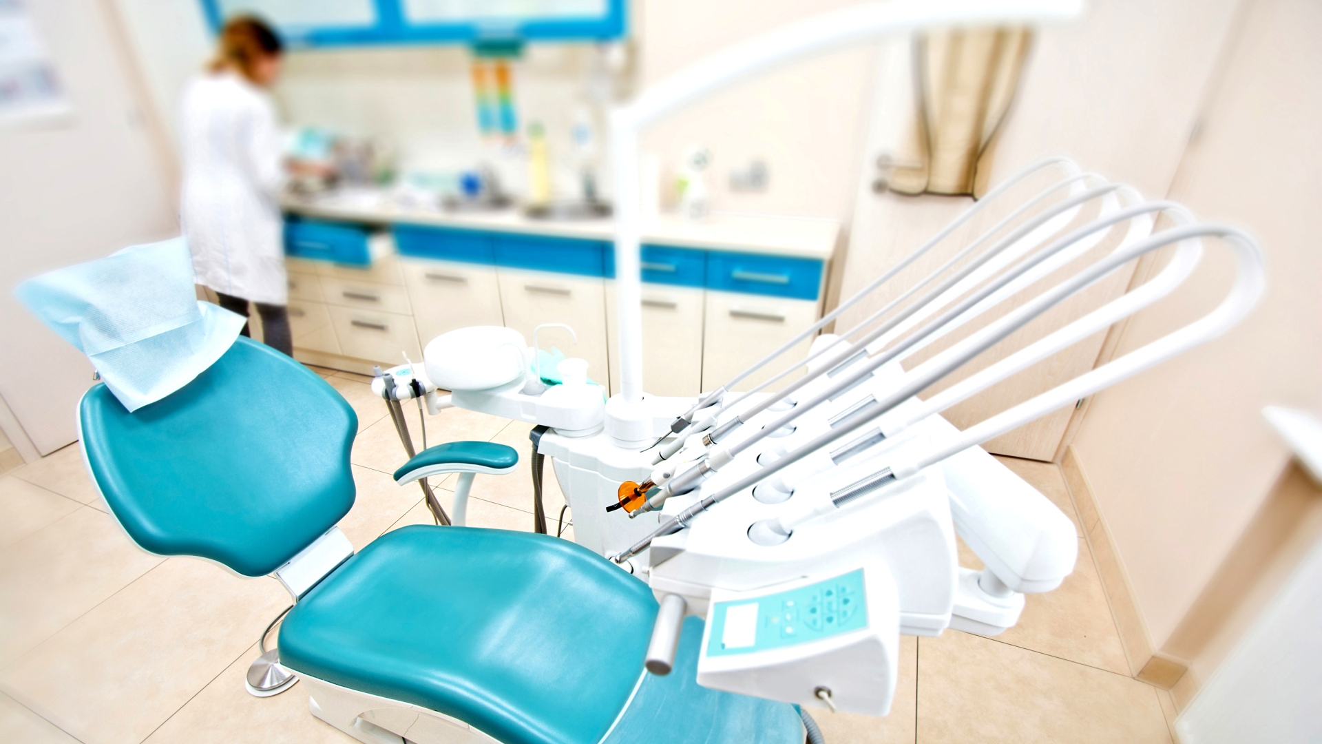 Professional Dentist tools and chair in the dental office. Dental Hygiene and Health conceptual image.